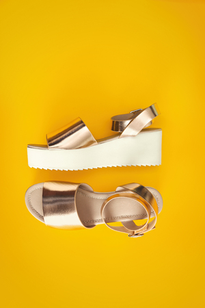 Female stylish shoes on color backgroundの写真素材