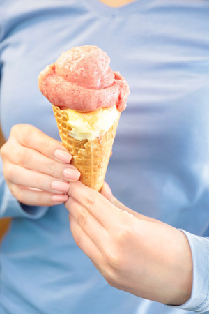 Woman holding portion of delicious ice cream, closeupの写真素材