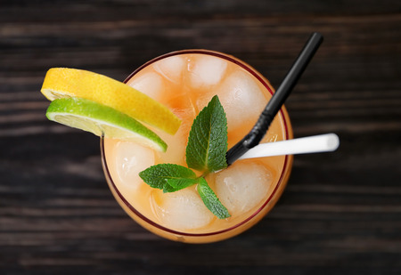 Glass of Tequila Sunrise cocktail on wooden table, closeupの写真素材