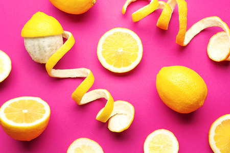 Delicious sliced and peeled lemons on color backgroundの写真素材