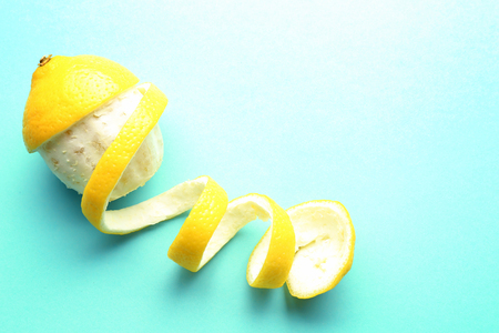 Delicious peeled lemon on color backgroundの写真素材