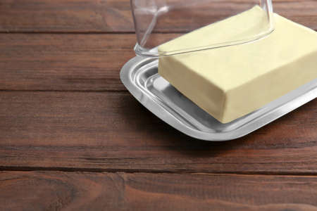 Dish with butter on wooden tableの写真素材