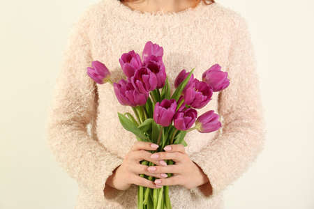 Young woman with bouquet of beautiful lilac tulips on white background, closeupの写真素材
