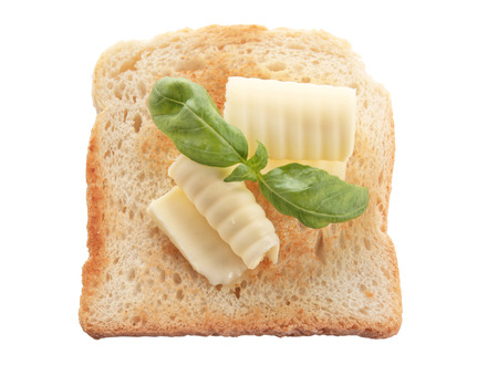 Slice of bread with butter curls on white background