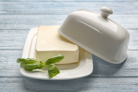 Dish with butter on wooden tableの写真素材