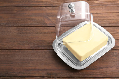 Dish with butter on wooden tableの写真素材