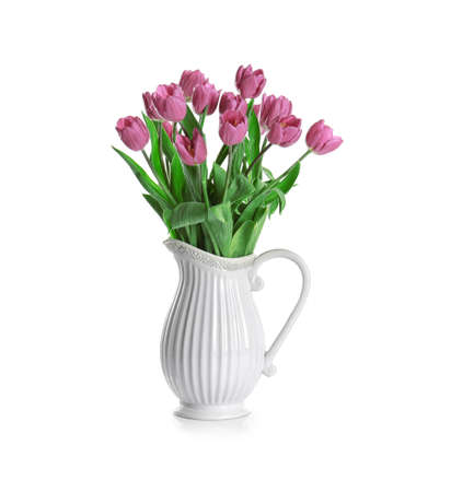 Vase with beautiful bouquet of lilac tulips on white backgroundの写真素材