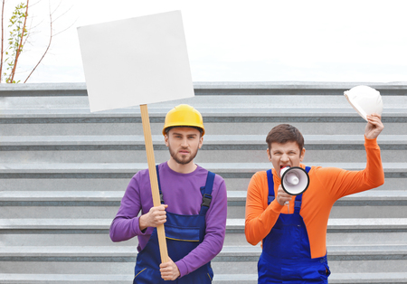 Protesting young men and fence on backgroundの写真素材