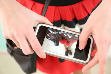 Woman taking photo of cute rat in bag, closeupの写真素材