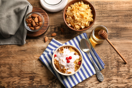 Delicious muesli with berries and yogurt on wooden tableの写真素材