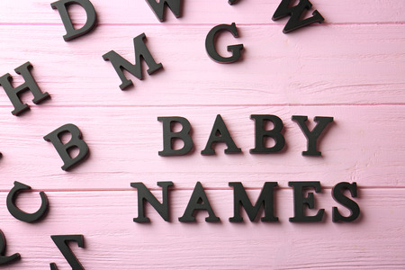 Words BABY NAMES on color wooden background. Concept of choosing baby nameの写真素材