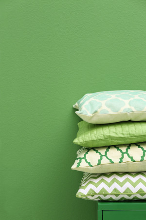 Stack of pillows on green backgroundの写真素材
