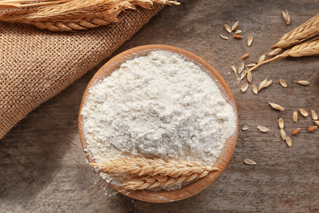 Bowl with flour on wooden tableの写真素材