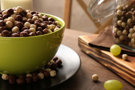 Healthy breakfast with corn balls and grapes on tableの写真素材