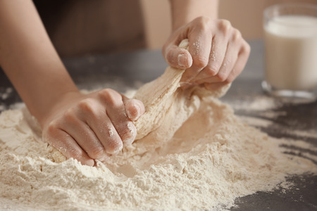 Female chef making dough in kitchenの写真素材