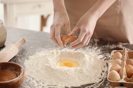 Female chef making dough in kitchenの写真素材