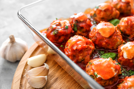 Delicious turkey meatballs in glass casserole dish on tableの写真素材