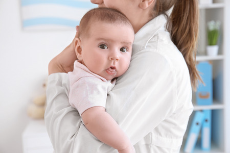 Female doctor and cute little baby in clinic. Baby health conceptの写真素材