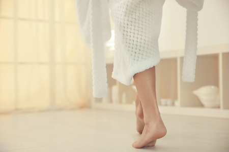 Young woman walking on floor after showerの写真素材