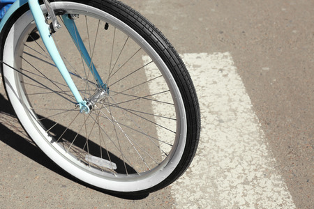 Bicycle wheel on zebra crossing, outdoor