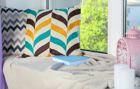 Window sill with book and pillows in the modern roomの写真素材