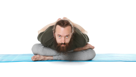 Young man practicing yoga on white backgroundの写真素材