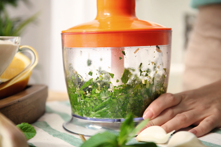 Woman preparing yogurt sauce in kitchenの写真素材