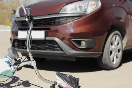 Car and bicycle accident on road of city streetの写真素材