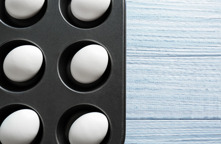 Hard boiled eggs in muffin tin on table