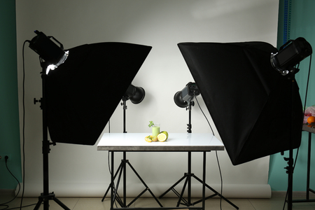 Professional equipment and juice in photo studio. Concept of food photographyの写真素材