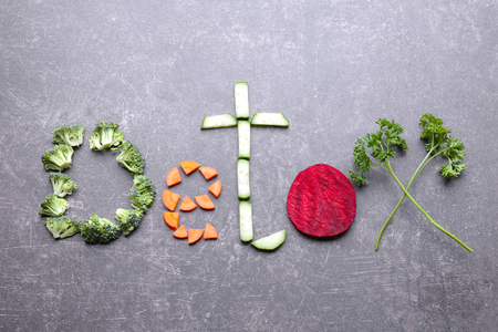 Word DETOX made of vegetables on grey backgroundの写真素材
