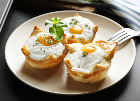 Tasty baked eggs in dough on plateの写真素材