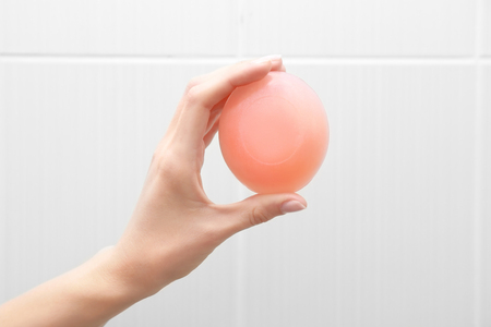 Hand of woman with soap in bathroomの写真素材
