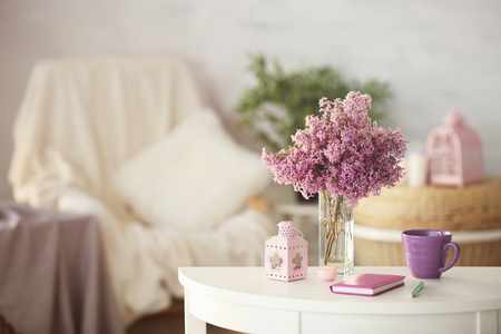 Glass vase with beautiful lilac flowers on tableの写真素材