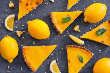 Composition with pieces of delicious lemon pie on textured backgroundの写真素材