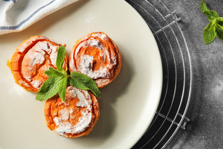 Plate with tasty carrot souffle on table