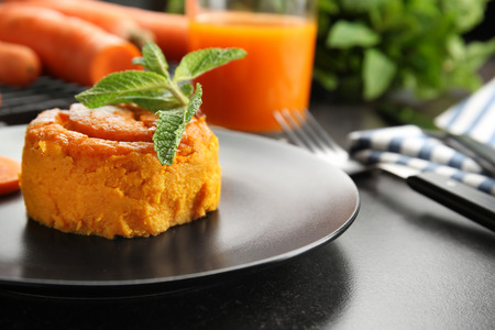 Plate with tasty carrot souffle on table, closeupの写真素材