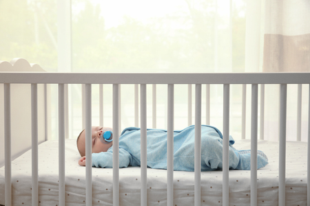 Cute little baby sleeping in cradle at homeの写真素材