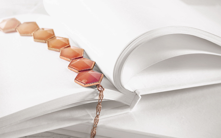 Open book with blank pages and beautiful necklace, closeupの写真素材