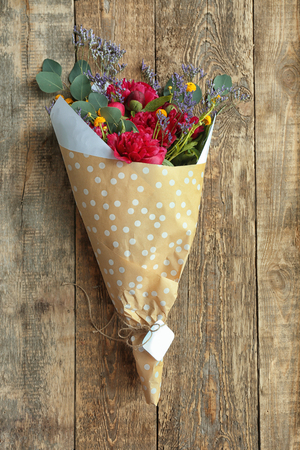 Bouquet with beautiful peonies on wooden backgroundの写真素材