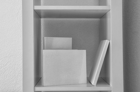 Books with blank white covers on shelfの写真素材