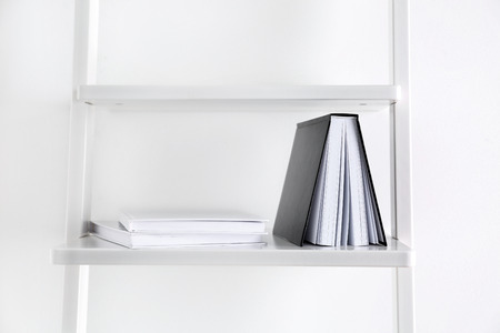 Books with blank covers on shelfの写真素材