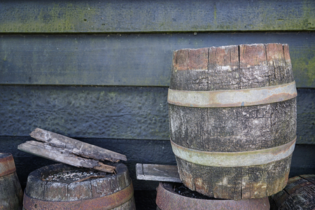 Wooden barrels and wall on background, outdoorsの写真素材