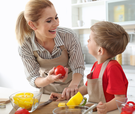 Mother and son making meal together in kitchen. Cooking classes conceptの写真素材