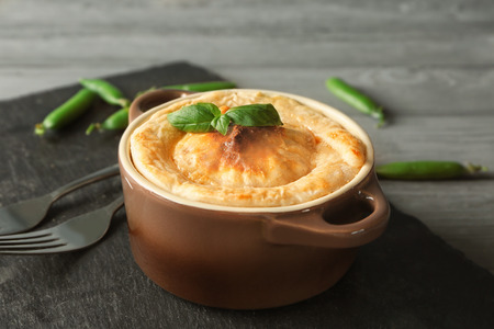 Baking dish with delicious turkey pie on tableの写真素材