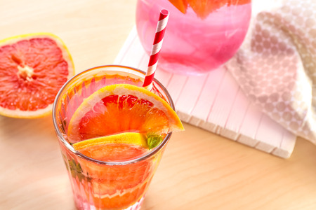 Glass of fresh grapefruit lemonade on wooden backgroundの写真素材
