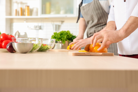 Chef giving cooking classes in kitchenの写真素材