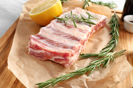 Raw ribs with rosemary on parchmentの写真素材