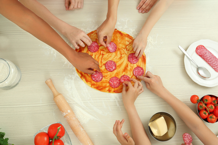 Group of children preparing pizza during cooking classesの写真素材