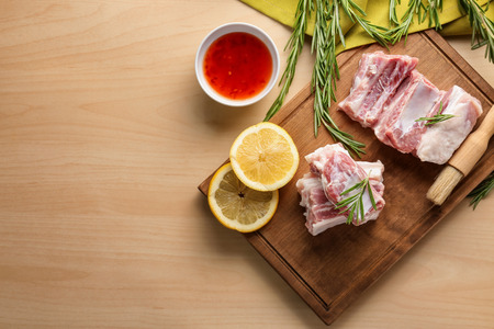 Raw ribs with ingredients on kitchen tableの写真素材